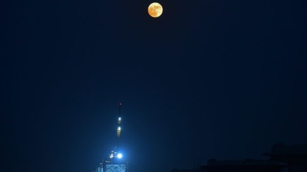 The Blue supermoon rises over the river Ganges, in Prayagraj on August 30, 2023 .