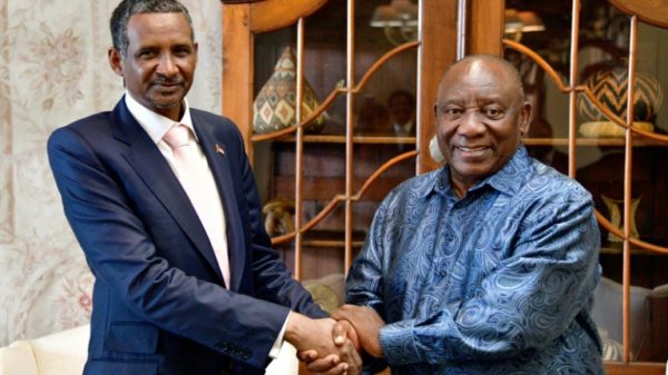 Sudan's paramilitary chief Mohamed Hamdan Daglo (L), with South African President Cyril Ramaphosa (R) in Pretoria, has been greeted as if he were a head of state, analysts say