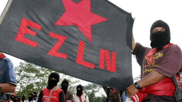 Supporters hold a banner of Mexico's Zapatista National Liberation Army (EZLN) at the Mayan archeological ruins of Palenque on January 3, 2005