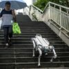 A robot dog walks down a pedestrian bridge in the Asian Games host city Hangzhou