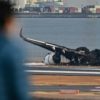 Charred remains of the planes were still littering one of Haneda's four runways