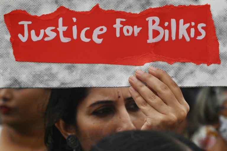 The case has sparked protests since the 11 convicts were released two years ago: in this August 2022 photograph a woman holds a placard in Mumbai demanding justice for Bilkis Bano