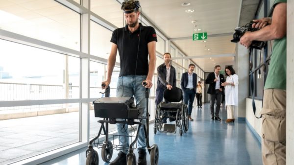 Gert-Jan, who is paralysed, walks using new technology that decodes his brain's signals