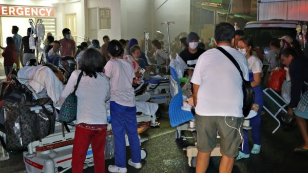 Patients are evacuated from a hospital in Butuan City after a magnitude 7.6 earthquake struck the southern Philippines