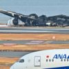 The burned-out wreckage of a Japan Airlines passenger plane sits on the tarmac at Tokyo's Haneda Airport
