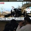 People at a railway station in Seoul watch a news broadcast with footage of one of North Korea's artillery firings