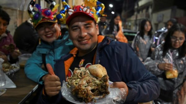 Customers brave the cold to queue up for their traditional sheep's head dish in Oruro