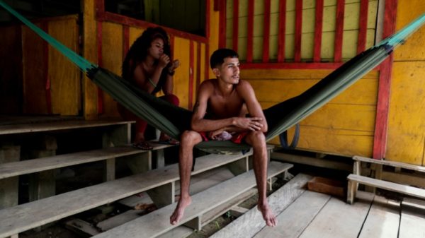 Two Venezuelans rest at their home in Mango Landing in Guyana