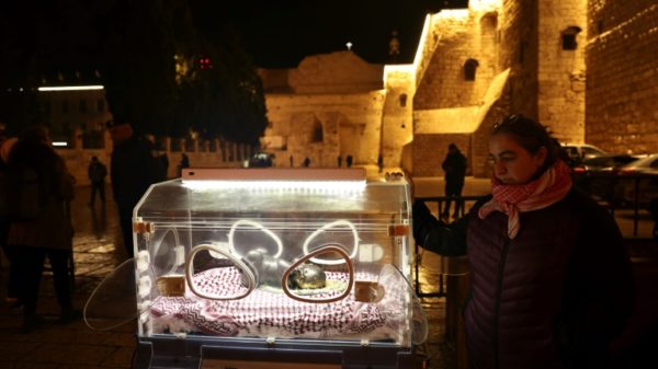An art installation in front of the Church of the Nativity in Bethlehem depicts the baby Jesus in an incubator