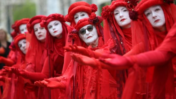 Members of performance troupe Red Rebel Brigade march in London at the Extinction Rebellion demonstration